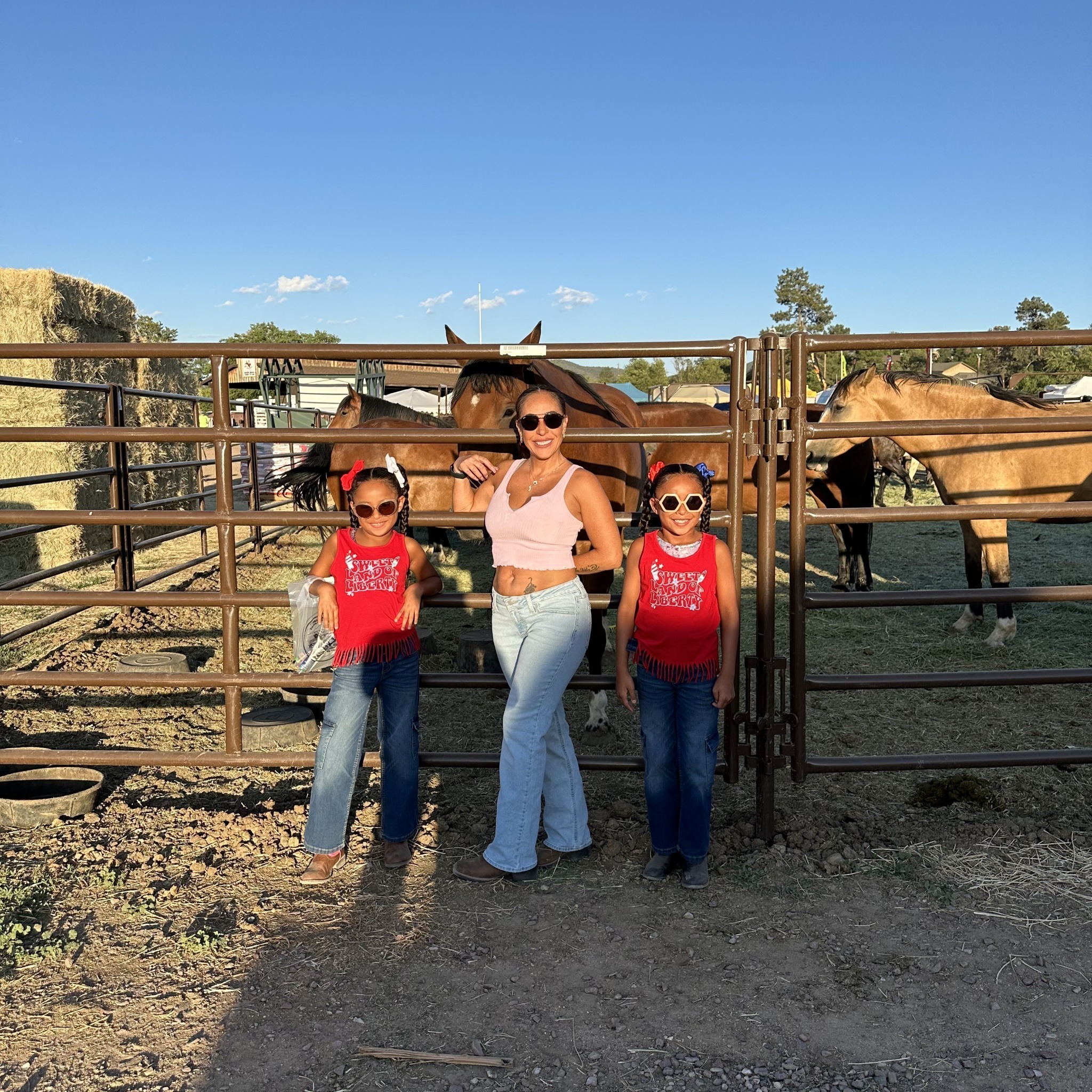 Family spending time with horses at the ranch